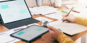 Person holding a pencil, designing a website.