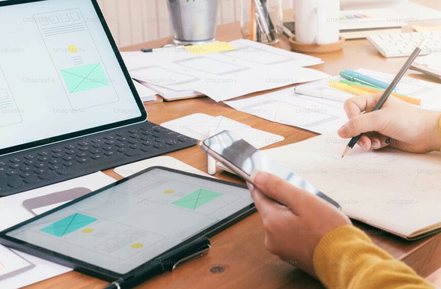 Person holding a pencil, designing a website.