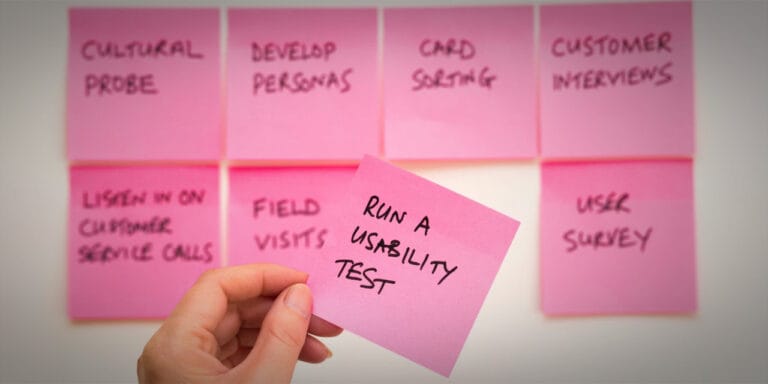 Whiteboard with post-it notes on the board. One reads "Book a usability test"