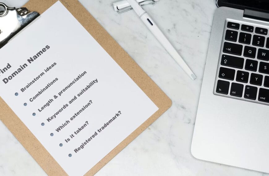 Checklist written on a clipboard showing list items to consider when planning a website, next to a laptop computer